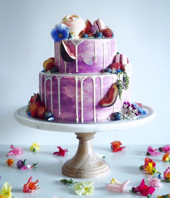 small purple wedding cake with fruit topping