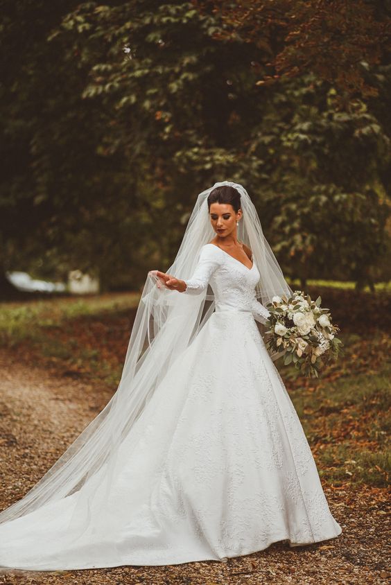 v neck ball gown wedding dress and a veil