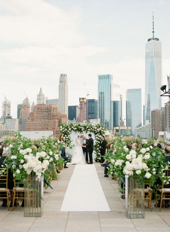Greenery aisle in rooftop wedding venue