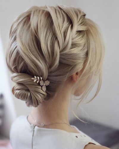Elegant twist braid low bun for pretty bohemian brides