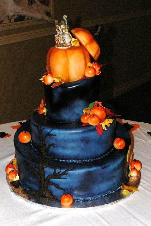 black navy cake with pumpkin topper