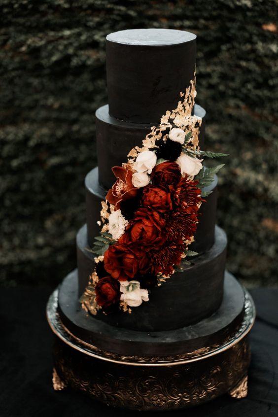 black wedding cake with burgundy adorments